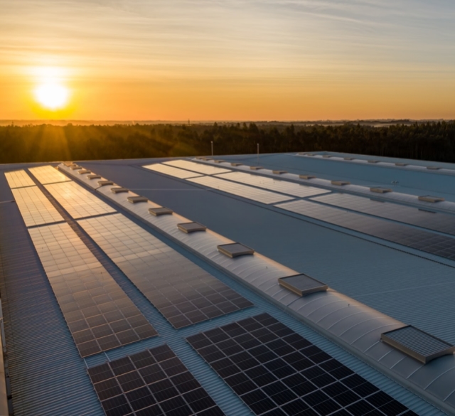 Solar panels installed on a rooftop at sunset